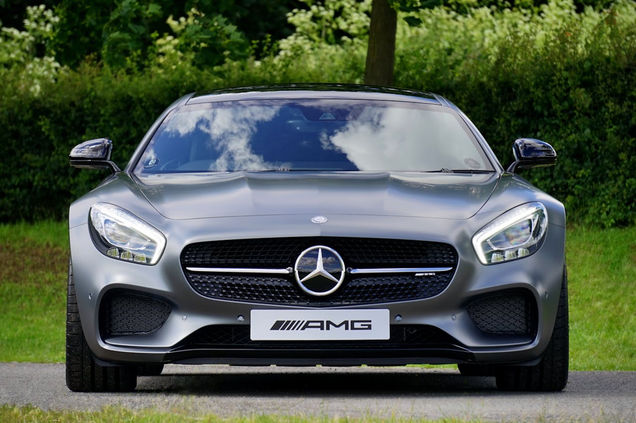 about-us Front view of a luxury Mercedes-Benz AMG against a natural backdrop.