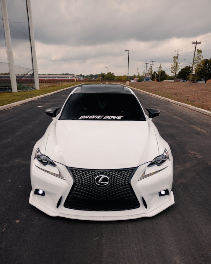 Sleek white Lexus sedan parked outdoors on a Philadelphia street, showcasing luxury and style.