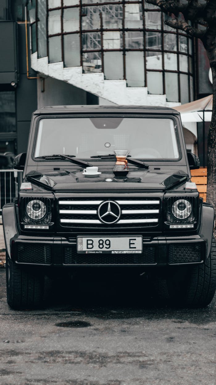 why-choose-us Front view of a black Mercedes-Benz G-Class parked in Bacău, Romania.